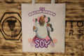 Tote bag de tela símil lino con el lema «Tu sugar daddy soy» y la ilustración de un hombre con barba, tutú rosa, alas de hada y piruletas