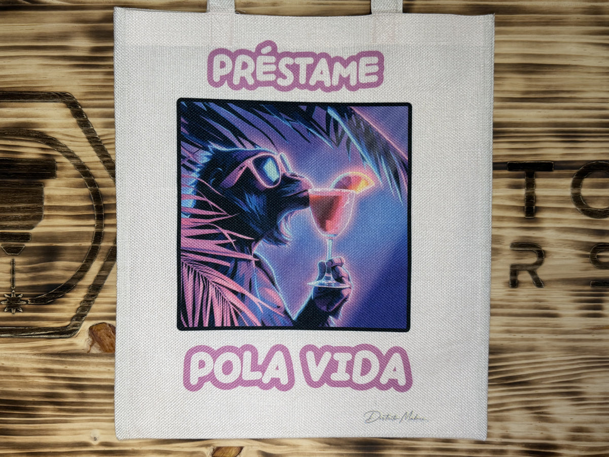 Tote bag de tela símil lino con el lema en asturiano «Préstame pola vida» y un felino con gafas de sol en colores neón