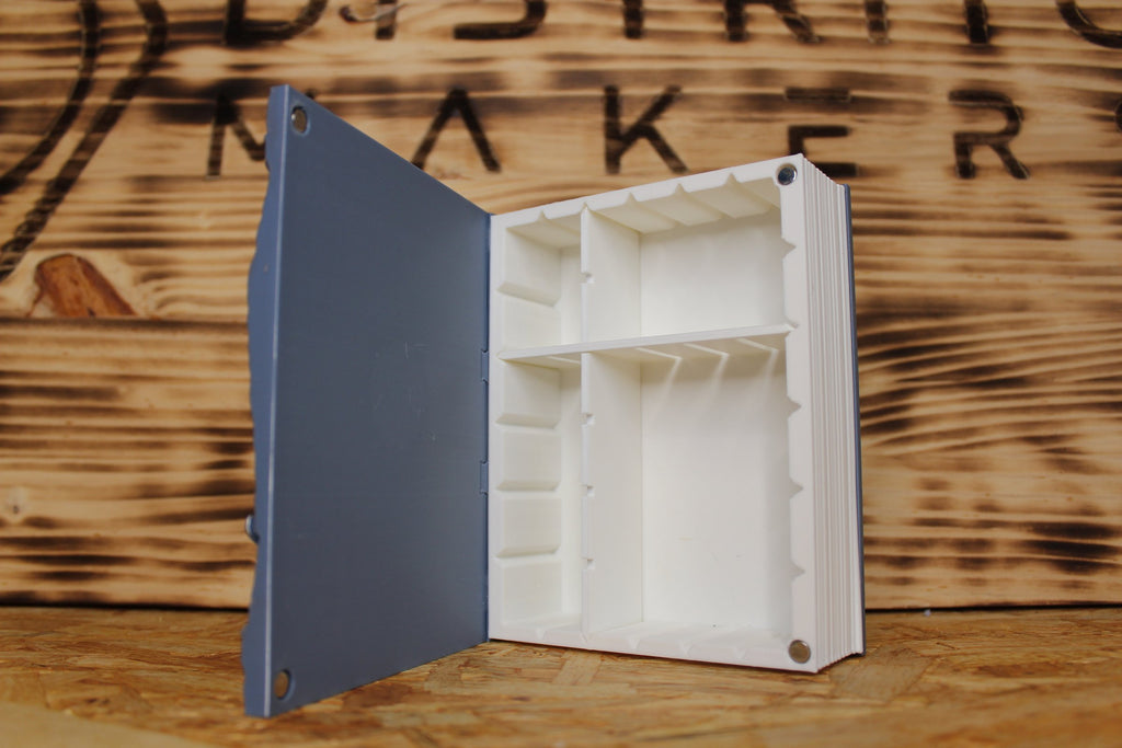 El Ojo del Cuélebre abierto, con el interior modular en blanco y los imanes del cierre